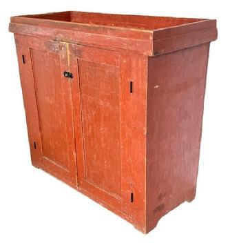 L132 Tall Pennsylvania mid-19th century Drysink bearing original red painted surface. Unique configuration features open well with applied chamfered molding around the base of the well over two doors that open to a clean, natural patina with shelving for added storage, resting on cut out feet. The wood is pine with square head nail construction. Circa 1850s. Measurements: 44 &frac12;� wide x 18 &frac34;� deep x 39 &frac12;� tall.   