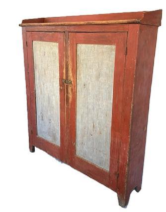 L298 Unusual early 19th century Lancaster County, Pennsylvania Storage Cupboard (Pantry) with original red and pewter gray painted surface featuring wide form with very unusual shallow 12-inch depth, an applied shaped gallery and cut out feet. This cupboard provides LOTS of storage opportunities within the clean, natural patina interior. The wood is pine, with square head nail construction. Both panel doors are fully mortised and pegged and surrounded by a deep beaded edge. Circa 1820s-1840s. Measurements: 55 &frac14;� wide x 13 &frac34;� deep (top) x 12� deep (case) x 63 &frac14;� tall (back) x 60� tall (front).
