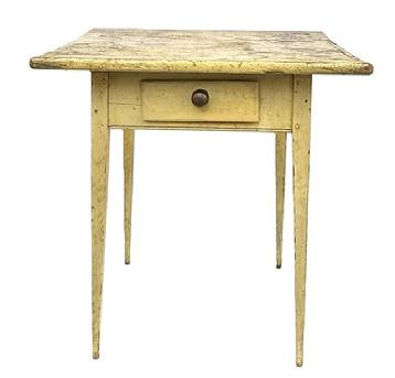 M149 Lancaster County, Pennsylvania Hepplewhite splay leg one drawer table with original mustard yellow painted surface resting on tall, very gracefully tapered splay legs. Mortised and wooden pegged construction with deeply carved beaded edge along the bottom edge of the apron on all sides. The drawer is square head nail construction with original brass knob. The wood is pine. Circa 1820s. One-board top. Measurements: 25� wide x 22 &frac12;� deep x 27 &frac34;� tall. 