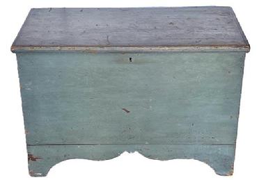**SOLD** L109 Mid-19th century New England original blue painted tall footed pine blanket chest featuring six-board, square head nailed construction with applied edge molding around the hinged lid all flanked by solid ends boasting a high, unusual cut-out "whale's tail" profile to the ends of the base and a decorative cutout along the front of the base. Clean, natural surface interior. Circa 1850s.  Measurements: 37 &frac34;� wide x 19 &frac14;� deep x 25 &frac34;� tall.  