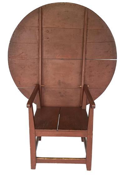 K251 19th century New England Chair Table, with the original red paint. The four-board pine top with generous overhang allows for comfortable seating. The chair base consists of a simple design that is fully mortised and pegged. Circa 1820s.  Top measures 47 &frac14;� x 46 &frac34;� and it is 27 &frac34;� tall. (It measures 60 &frac34;� tall with the top in the up/stored position). The base measures 22 &frac14;� wide x 26 &frac34;� deep.  