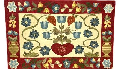 M1125 Exceptional identified, dated and award winning Mid-Atlantic hand-hooked rug with a central floral and heart motif surrounded by a 5 &frac12;� wide border featuring tall urns of flowers on each end and vines and flowers along top and bottom. The initials �JTK� and date �2007� are hooked within the center of the heart. A First-Place Blue Ribbon dated 2009 from the Maryland State Fair Timonium is attached. Vibrant colors of wool strips are tightly hand hooked on Monk�s cloth. Mounted and ready to hang. Measurements: 48� wide x 31� tall. (�JTK� = Julie T. Kappler). 