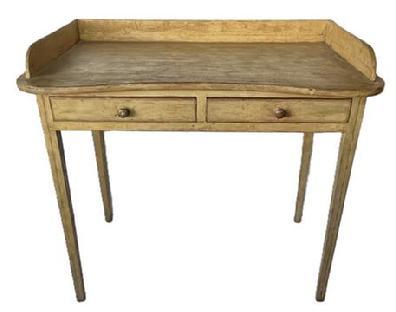 K1810 19th century Pennsylvania original mustard painted pine table with two drawers and shaped top with gallery resting on tall, delicately tapered Hepplewhite legs. Painted surface retains remnants of original black pinstripe decoration throughout. Square head nail construction with apron being fully mortised into the legs. Measurements: 37 &frac14;� wide x 21� deep x 33 &frac12;� tall (back) x 30 &frac34;� tall (front). Apron to floor is 25�.  