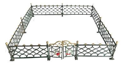 L453 Cast Iron Christmas Fence with hinged double gate bearing original green and gold painted surface. Gold painted sunburst pattern toppers run along top edges and cannonball finials adorn the end post of each panel.   