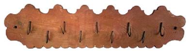 M110 19th century Wood and Wrought Iron Meat / Game Rack bearing original red washed surface, with nine delicate hand-forged wrought iron hooks clinched to a pine board boasting a decorative shaped edge along the top and a scalloped edge along the bottom. Square shaped hole on each end for hanging purposes. Circa 1850s. Measurements: 31 &frac34;� long x 8 &frac14;� tall x &frac34;� thick. 
