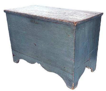 **SOLD** L109 Mid-19th century New England original blue painted tall footed pine blanket chest featuring six-board, square head nailed construction with applied edge molding around the hinged lid all flanked by solid ends boasting a high, unusual cut-out "whale's tail" profile to the ends of the base and a decorative cutout along the front of the base. Clean, natural surface interior. Circa 1850s. Measurements: 37 &frac34;� wide x 19 &frac14;� deep x 25 &frac34;� tall.   