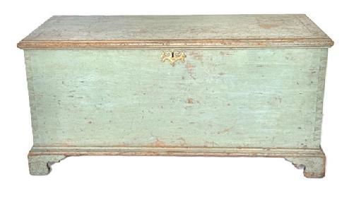 **SOLD** X33 Exceptional form 18th century Berks County, Pennsylvania Chippendale style Blanket Chest with the original dry blue paint featuring a dovetailed case with outstanding applied bracket base bearing beautiful cut out feet and a molded edge surrounding the top that is secured with wooden pegs.  The brass Chippendale escutcheon is original to the chest. The interior bears clean, natural patina and boasts the original fish tail hinges and a lidded glove box. Circa 1770s. Measurements: 44 &frac12;� wide x 20� deep x 21� tall.  