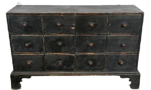  L406 19th century New England 12 drawer Apothecary in original Windsor green paint with dovetailed case and drawers, resting on an applied bracket base with decoratively cut out feet.  The wood is pine with small wire nail and dovetail construction. Circa 1840s.  Measurements: 34 &frac12;� wide x 10 &frac12;� deep (top) x 11 &frac12;� deep (base) x 22� tall.  