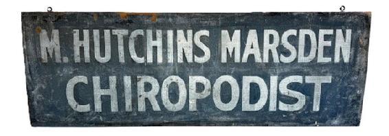 H933 19th century Adverting Sign for �M. HUTCHINS MARSDEN�  �CHIROPODIST� in white lettering on a dark blue sand painted background. The double-sided sign is painted on a single board with one side having slightly molded edges. Two early iron eye hooks remain intact on the top edge of the sign for hanging purposes.  Measurements: 40 &frac14;� wide x ~7/8� thick x 13 &frac34;� tall.  