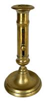 M142 19th century solid Brass Push Up Candlestick. Nice, heavy weight and the push-up feature is fully functional. Measurements: 4 1/8� bottom diameter x 8� tall.  