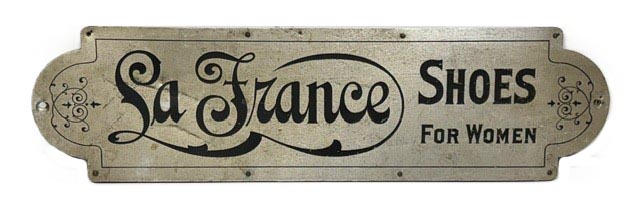 M1153 Early 20th century Trade sign advertising &ldquo;La France Shoes for Women&rdquo;. Metal front on a wooden framed back. La France Shoe Company was established in Lynn, Massachusetts in the early 20<sup>th</sup> century and became a national brand that was iconic between 1900 and the 1920s for their elegant, tailored women's shoes with 'comfort arch'.
